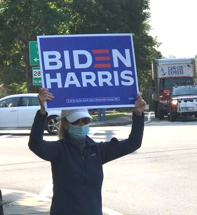 Canvasser holding a Biden-Harris sign